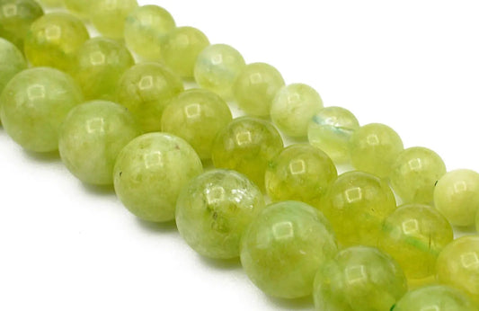 "Polished green jade gemstone beads on white background"