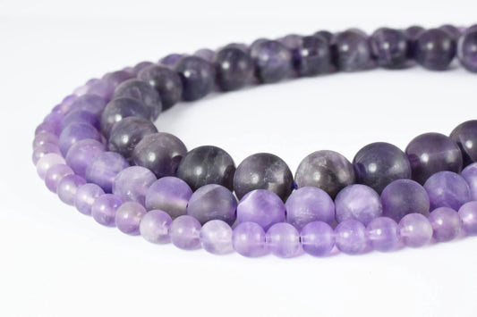 Purple amethyst bead necklace on white background.