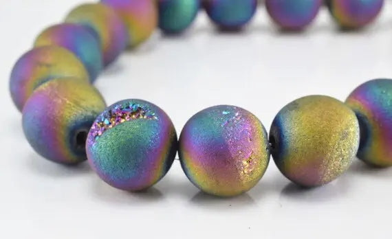 Multicolor round druzy beads bracelet on white background.