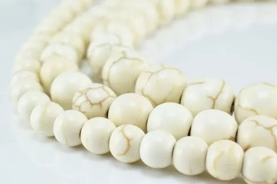 White marble bead necklace on a light background.