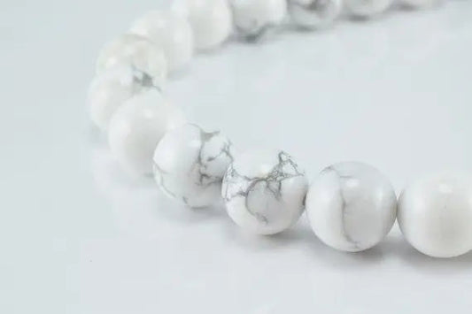 White howlite gemstone bead bracelet on clean background.