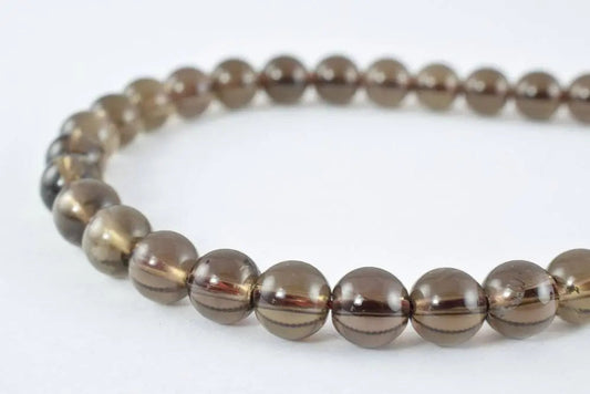 "Round smoky quartz gemstone bead bracelet on white background"