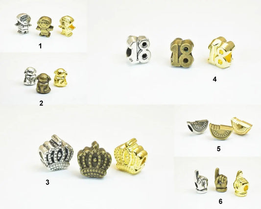 Assorted metal charm beads in silver and gold featuring figures, crowns, numbers, and hands for jewelry making.