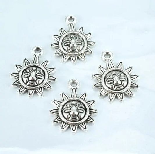 "Four silver sun face charms for jewelry making"