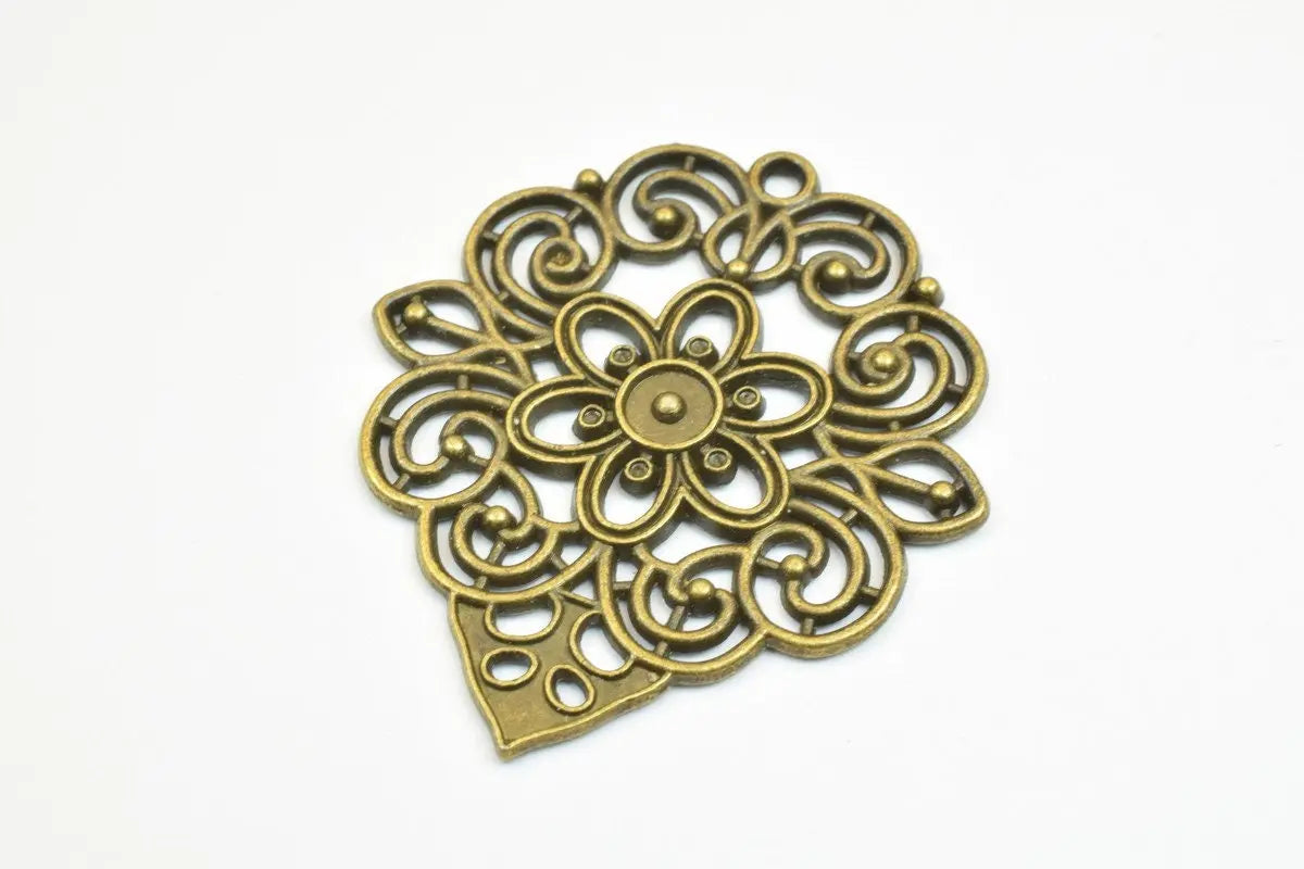 Intricate antique brass floral metal pendant.