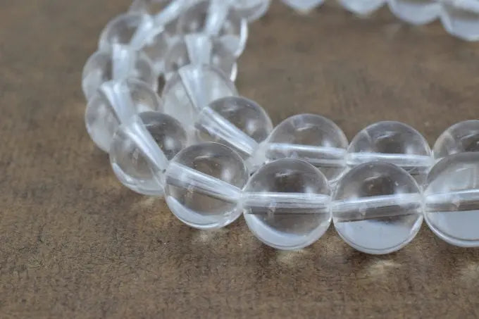 Clear crystal bead bracelet on a wooden surface.