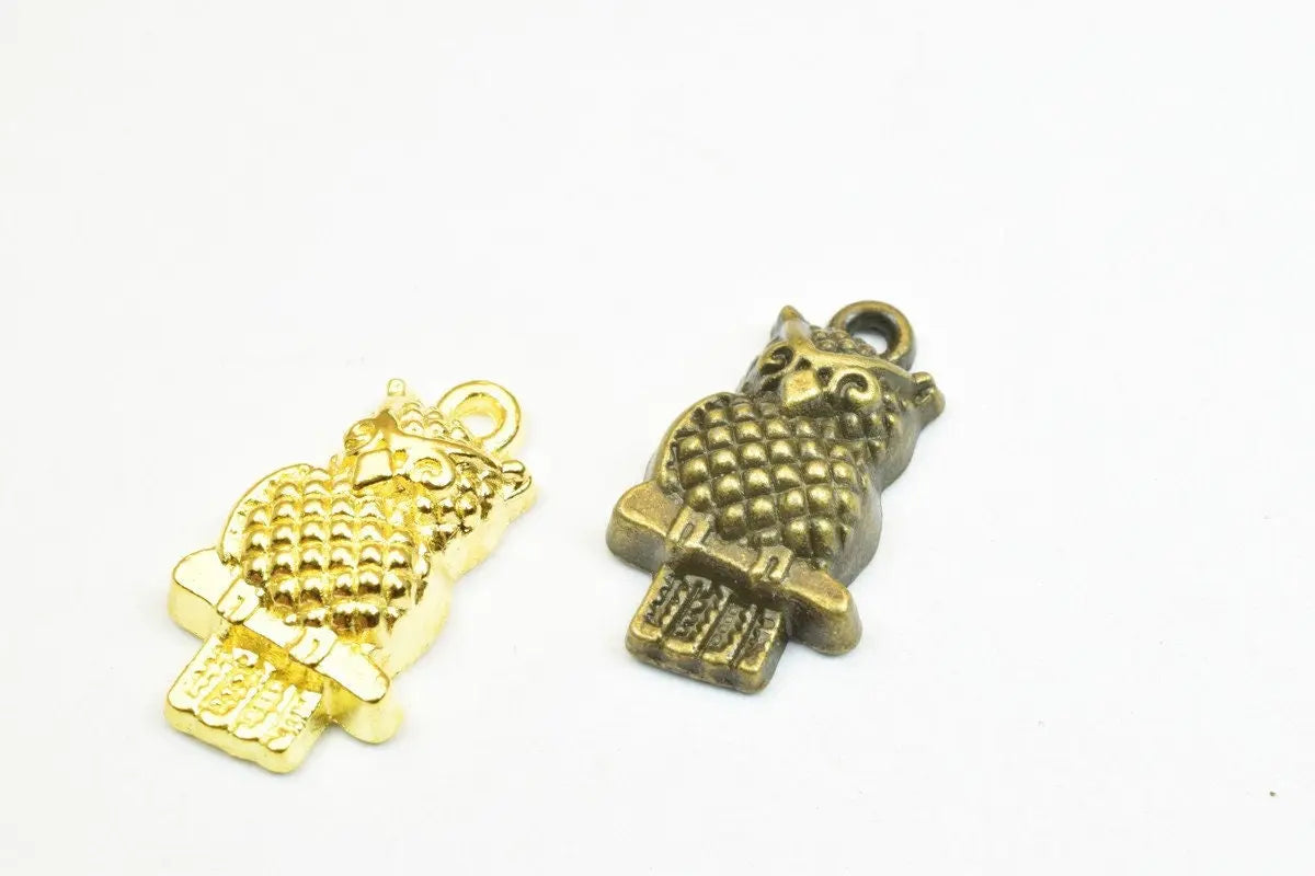 Gold and bronze owl charms for jewelry making.