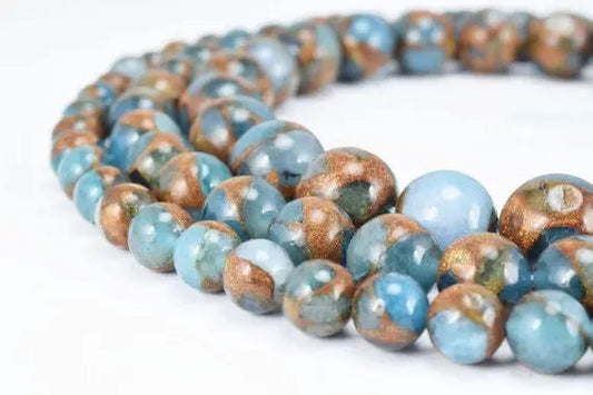 Blue and gold marble bead necklace on white background.