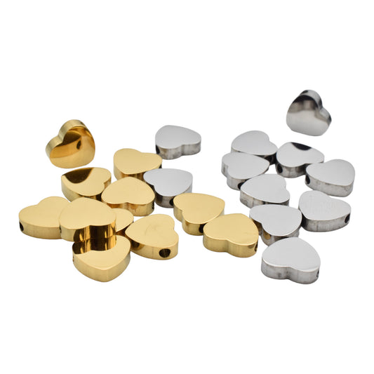 Gold and silver heart-shaped metal beads for jewelry making.