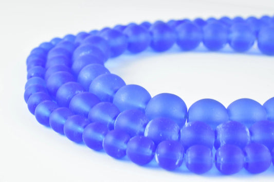 Blue frosted glass beads close-up on necklace.