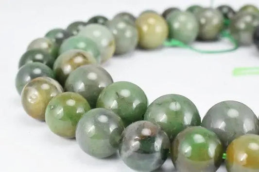 Green jade gemstone beads necklace on a white background.