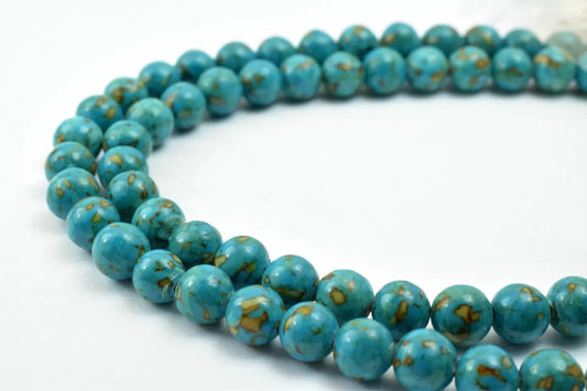 Alt text: "Turquoise gemstone bead necklace with marbled pattern on white background"