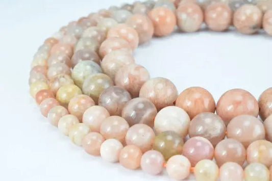 Polished multicolor moonstone gemstone beads in varying sizes.