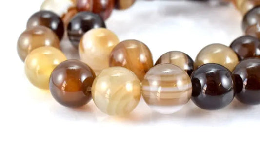 Multi-colored agate bead bracelet close-up on white background.