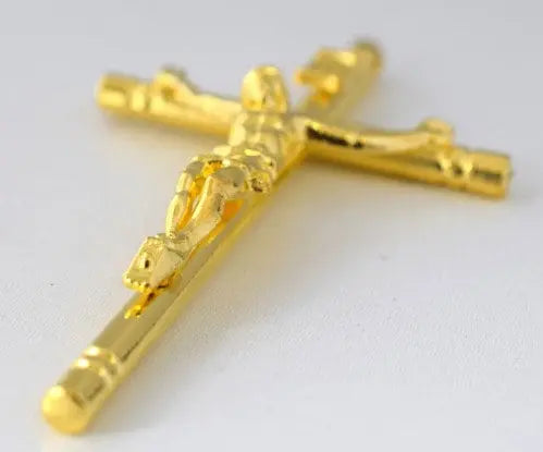 Gold crucifix pendant on white background