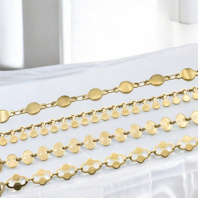 Gold geometric chain bracelet collection displayed on white surface.