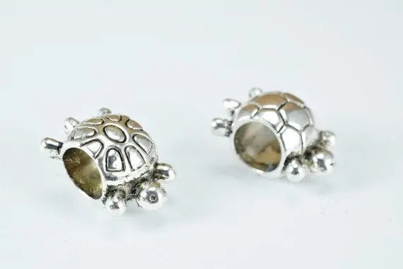 Silver turtle-shaped charm beads for jewelry making.