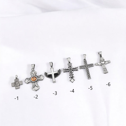 Silver cross pendant collection on white background.