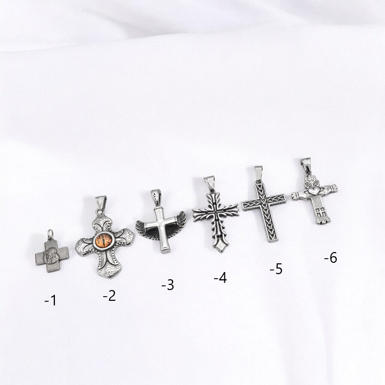 Silver cross pendant collection on white background.