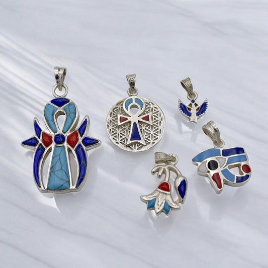 Silver and blue Egyptian-themed gemstone pendants on a white background.