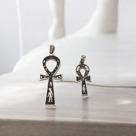 Silver Ankh pendant with detailed engravings on white background.