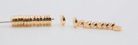 Gold circular disc spacer beads for jewelry making.