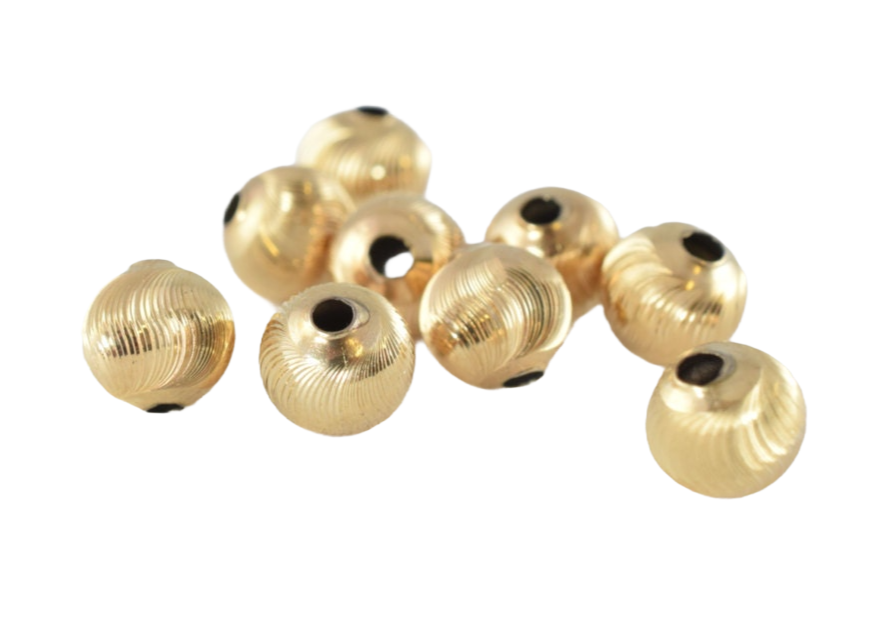 Gold textured metal beads for jewelry making.