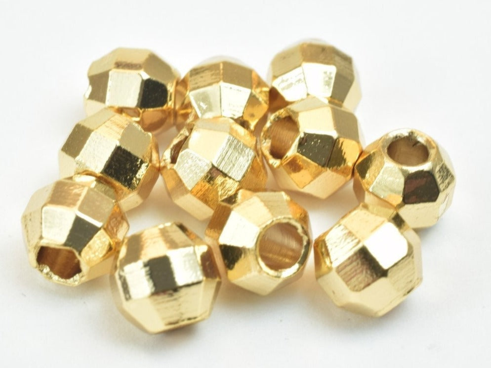 Faceted gold spacer beads for jewelry making.