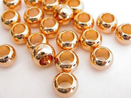 Gold round spacer beads for jewelry making.