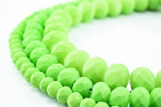 Faceted lime green glass bead necklace on white background.