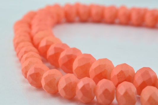 Coral faceted glass bead strand for jewelry making.