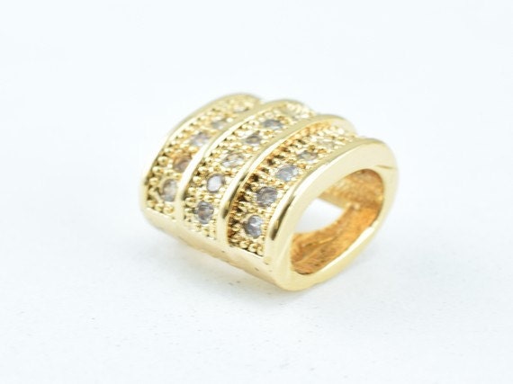 Gold three-band ring with crystal embellishments.