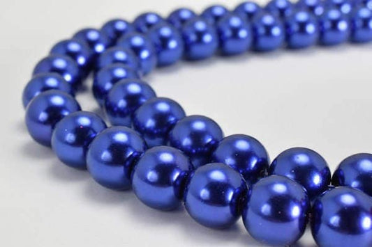 Blue pearl bead necklace on a light background.