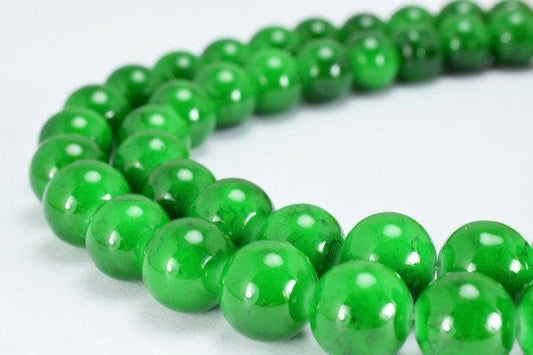 Green jade bead necklace on white background.