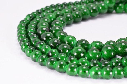 Green jade bead necklace close-up on white background.