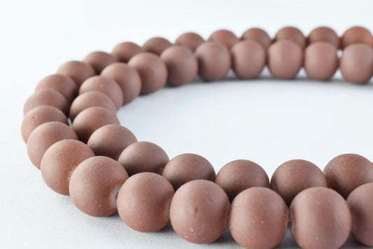 Brown wooden bead necklace on white background.