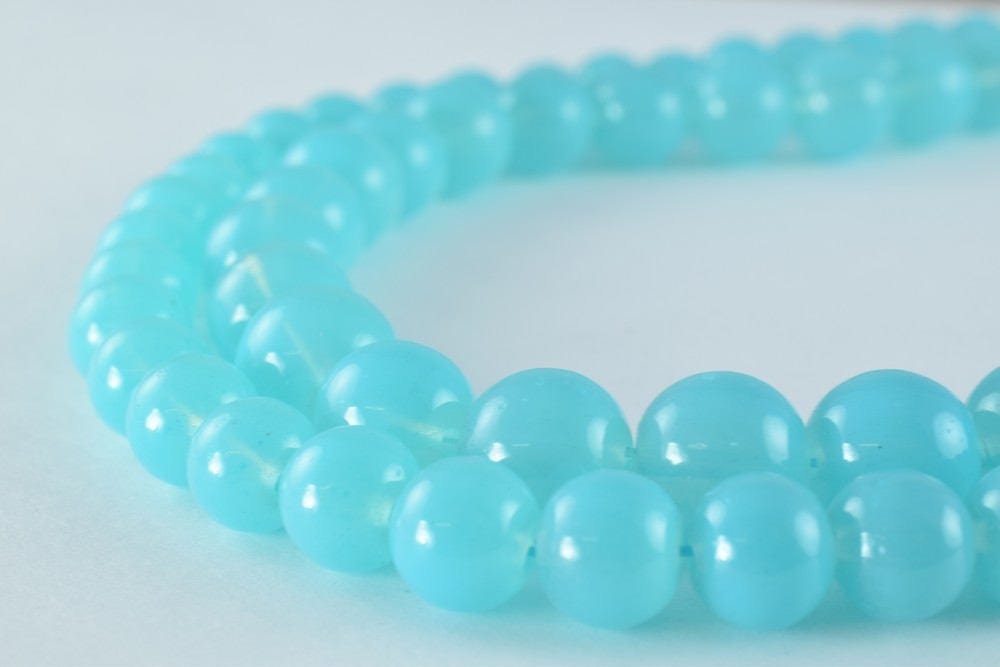 "Blue glass bead necklace close-up on white background"