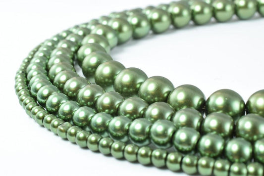 Green freshwater pearl necklaces arranged in layers.