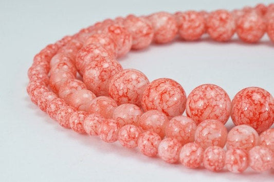 Pink marble glass bead necklace set, round beads, close-up view.