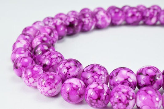 Purple marbled glass bead necklace on white background.