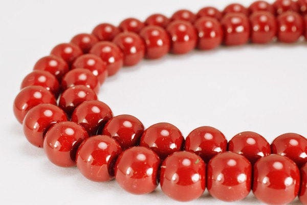 Red coral bead necklace close-up for jewelry collection.