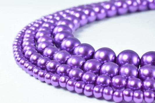 Purple pearl bead necklace strands.