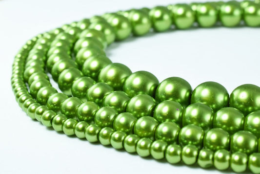 Green pearl bead necklaces in various sizes displayed on a light background.