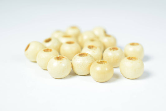 Natural wooden beads on white background.