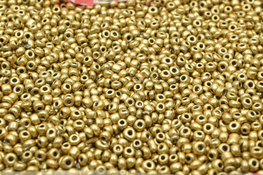 Gold seed beads pile for jewelry making supplies.