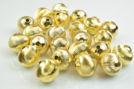 Ribbed round gold beads for jewelry making.