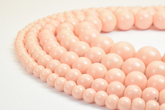 "Close-up of pink beaded necklace on white background"