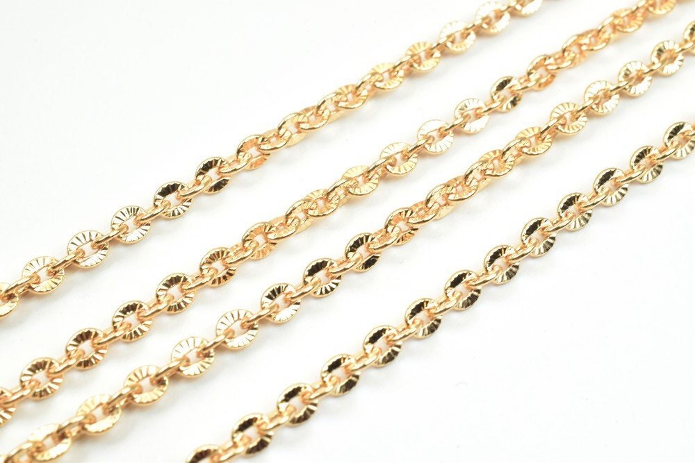 Golden chain necklace with circular links on white background.