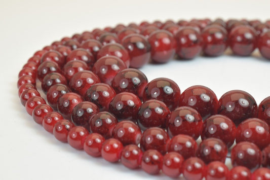 Red agate gemstone bead necklace close-up.