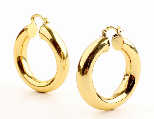 Gold hoop earrings with latch closure on white background.